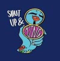 Shut Up and King logo - A digital graphic-style illustration of a hand with blue skin and colourful wrist tattoos holding a gold and pink compact mirror. The mirror reflects bold red lips in a smirk, and a black moustache. The text beside it reads “shut up and king”. The background is dark blue.